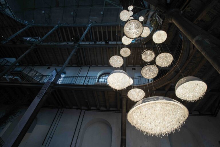 Bespoke crystal chandelier installation by Manooi in a historic interior